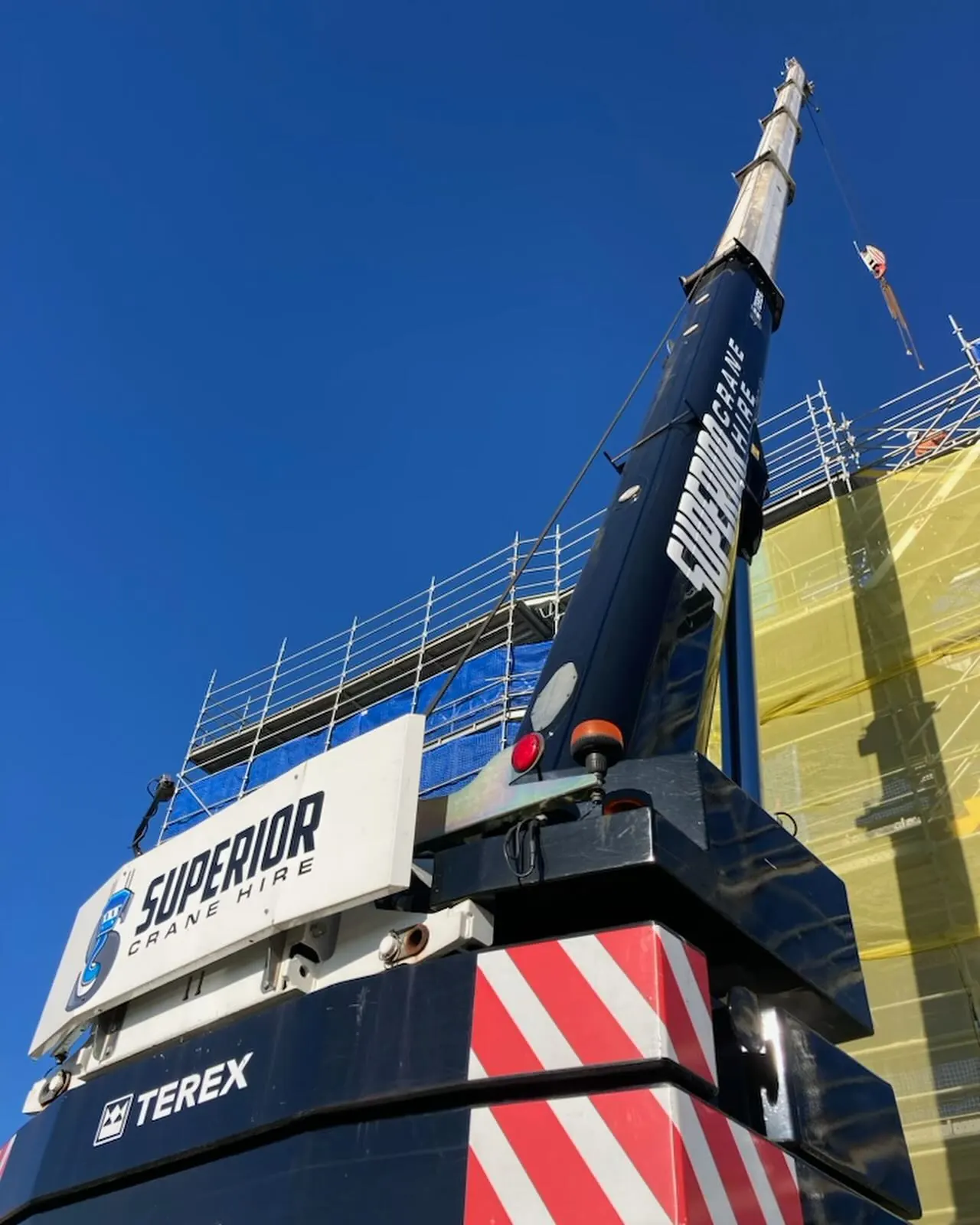 Superior boom and hook block against a blue sky