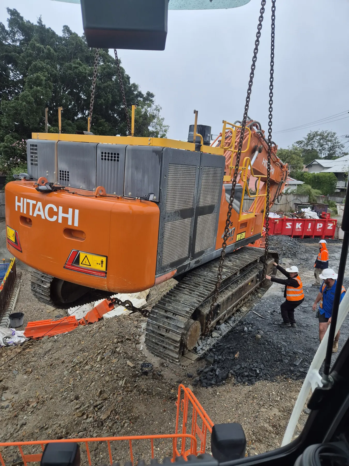 Excavator lifted into a city basement