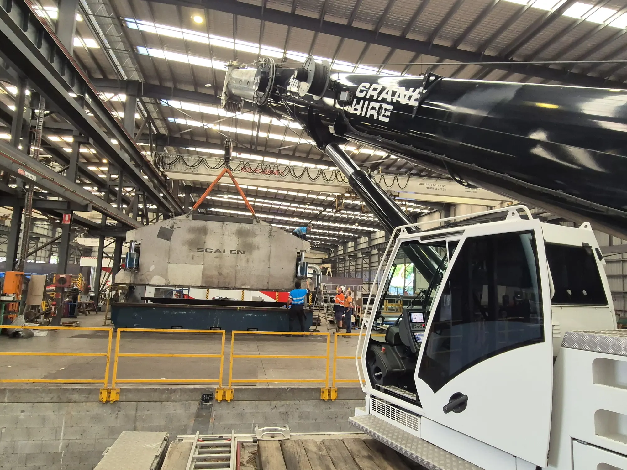 A crane working inside a factory