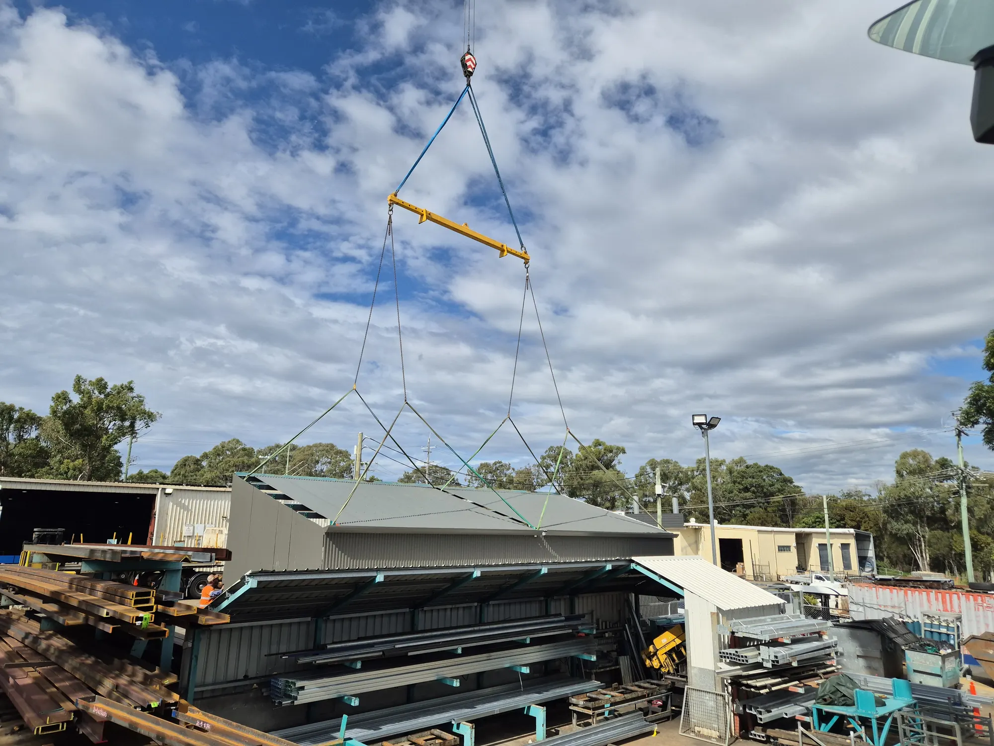 A roof frame lifted over a workshop