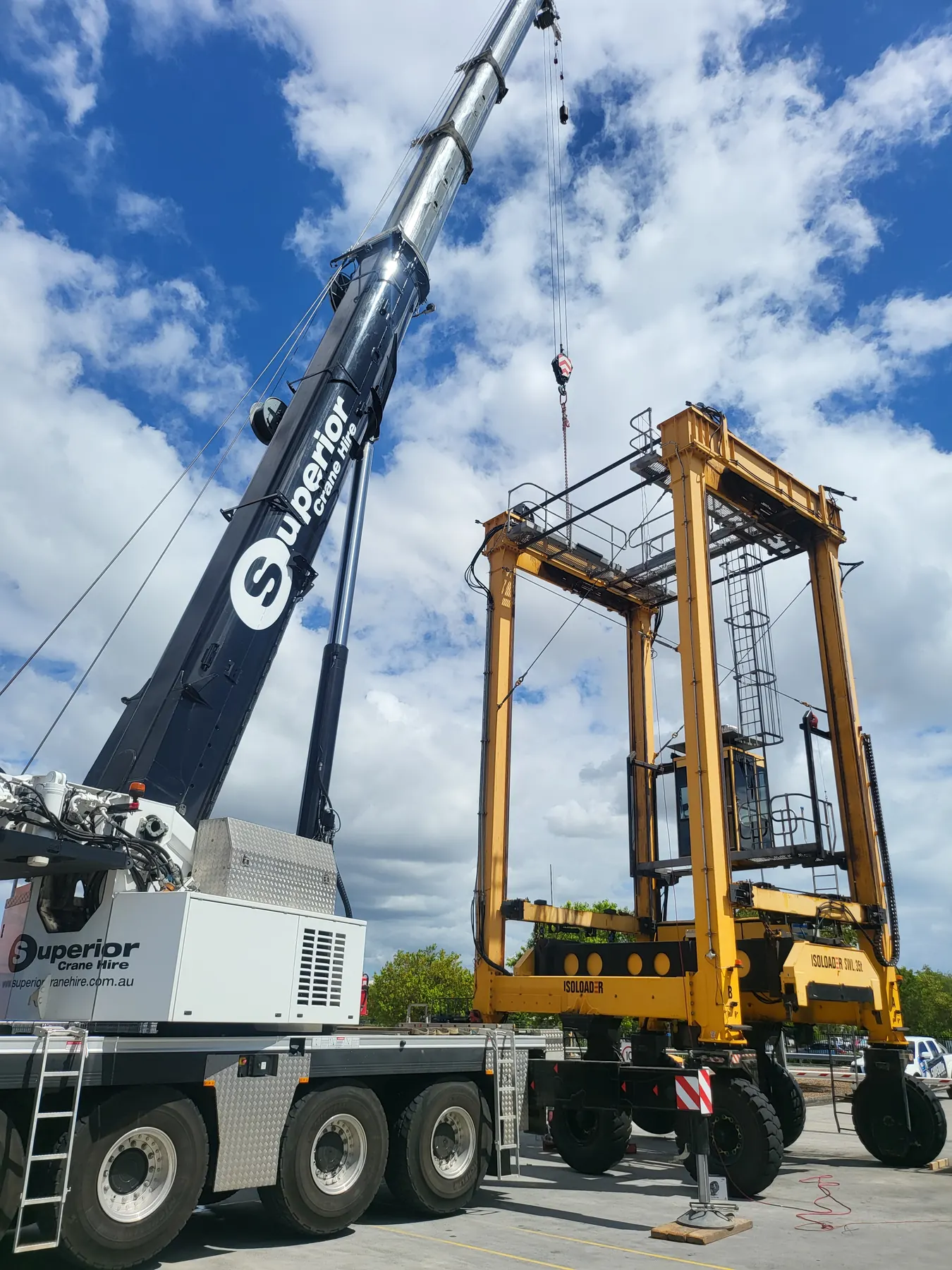 Crane lifting a straddle carrier