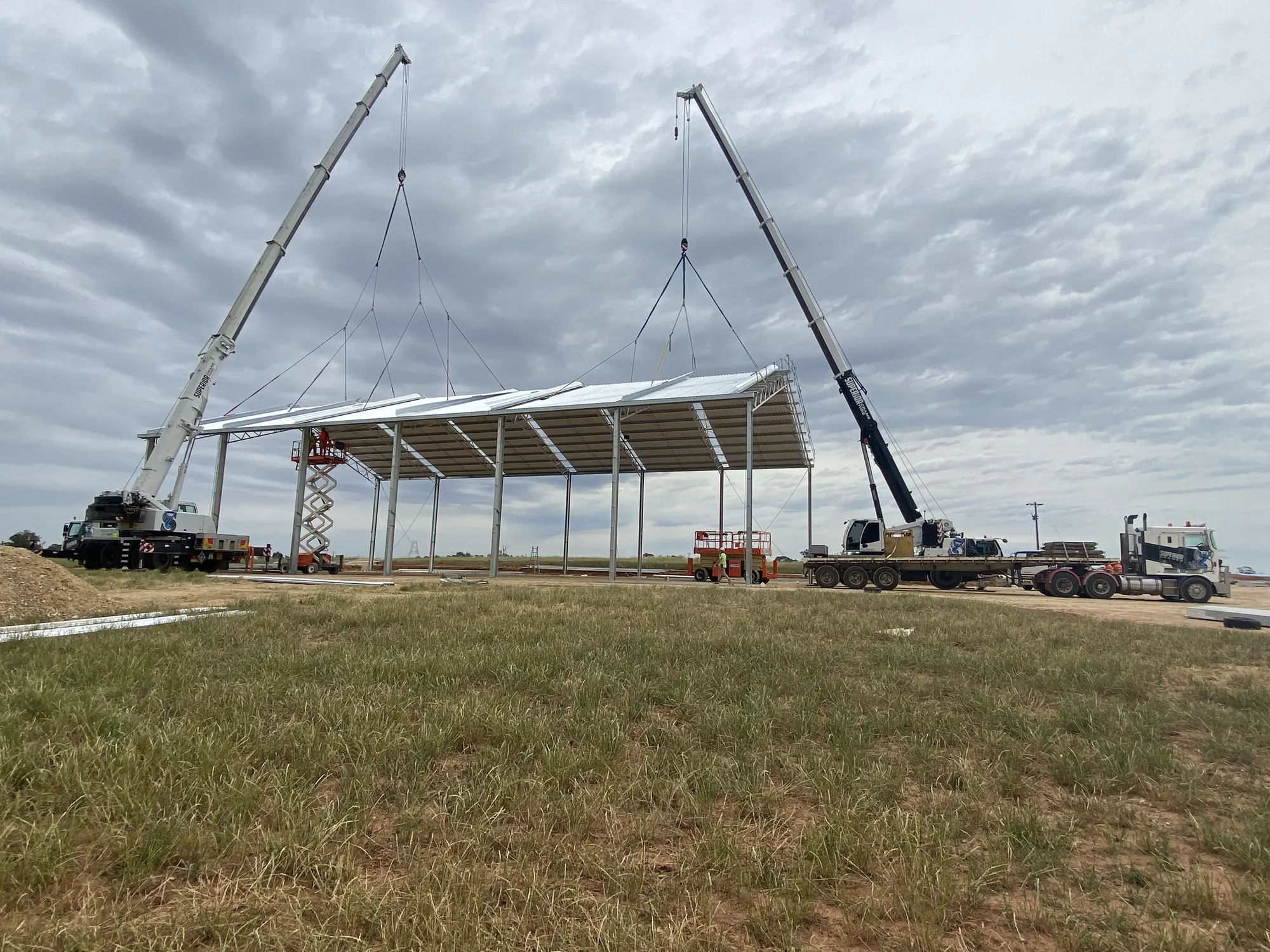 Two cranes in a tandem lift of a roof structure